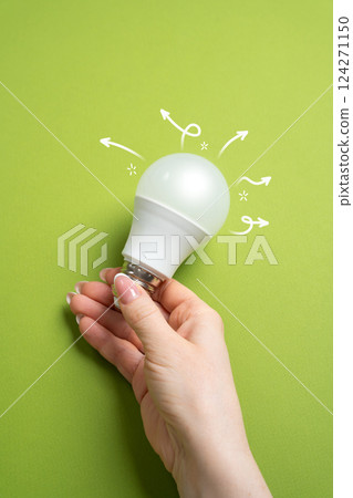 Idea and motivation for development. Light bulb in hand. Creativity, and innovation. Achieving success through inspired thinking. 124271150