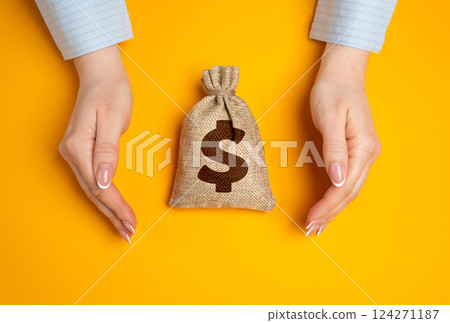 Hands in a gesture of protection of money bag. Concept of capital protection and guarantee of safety of investments and deposits. Financial security. Secure savings 124271187