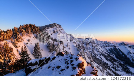 The snowy landscape of the Kuroboyama mountain ridge dyed in the morning glow The snowy landscape of the Kuroboyama mountain ridge dyed in the morning glow 124272218