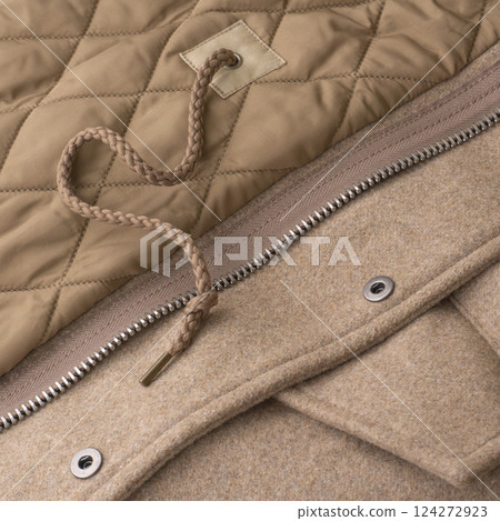 Close-up of interior details of a light beige wool coat 124272923