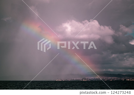 Bright rainbow over the ocean after a rainstorm, New Zealand Bright rainbow over the ocean after a rainstorm, New Zealand 124273248