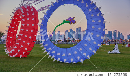 Qatar Kite Festival 2025 in Old Doha port (Mina District) sunset shot showing spectacular showcase of colorful kites soaring across the Doha skyline Qatar Kite Festival 2025 in Old Doha port (Mina District) sunset shot showing spectacular showcase of colorful kites soaring across the Doha skyline 124273268