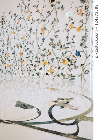 View of Sheikh Zayed Grand Mosque in Abu Dhabi made of white marble with flowers made of precious stones in design. Inside mosque. Vertical photo 124273595