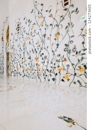 View of Sheikh Zayed Grand Mosque in Abu Dhabi made of white marble with flowers made of precious stones in design. Inside mosque. Vertical photo 124273605