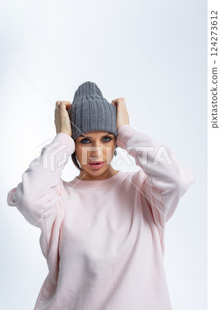 Portrait beautiful woman in grey hat. Pretty girl in warm clothes on grey background. Studio photography. Vertical photo. High quality photo Portrait beautiful woman in grey hat. Pretty girl in warm clothes on grey background. Studio photography. Vertical photo. High quality photo 124273612
