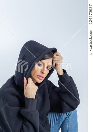Portrait beautiful woman of model appearance. Girl in black sweatshirt on grey background. Pretty female with trendy makeup posing in studio. Vertical photo. High quality photo Portrait beautiful woman of model appearance. Girl in black sweatshirt on grey background. Pretty female with trendy makeup posing in studio. Vertical photo. High quality photo 124273627