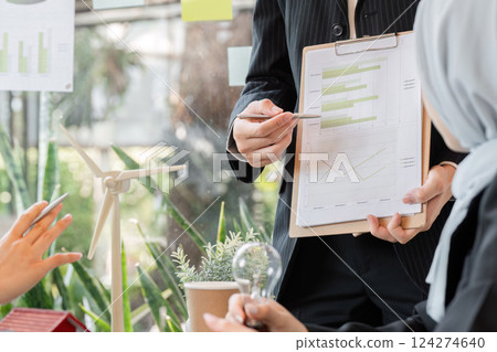 Data Analysis and Eco Sustainability. A professional presents a sustainability report in a corporate meeting. 124274640