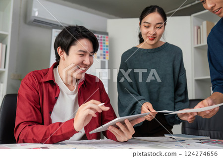 Engaging Teamwork in Design Concepts. Group members discussing and reviewing design ideas while smiling and collaborating. Engaging Teamwork in Design Concepts. Group members discussing and reviewing design ideas while smiling and collaborating. 124274656