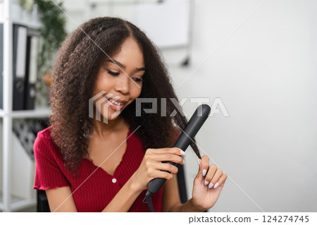 Beauty Ritual and Natural Hairstyles. A woman enjoys hairstyling in a cozy environment. Beauty Ritual and Natural Hairstyles. A woman enjoys hairstyling in a cozy environment. 124274745