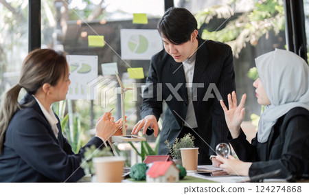 Sustainability and Team Collaboration. A business meeting focused on sustainable practices and environmental solutions among professionals. Sustainability and Team Collaboration. A business meeting focused on sustainable practices and environmental solutions among professionals. 124274868