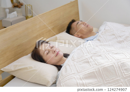 Couple sleeping in a double bed in the morning 124274907