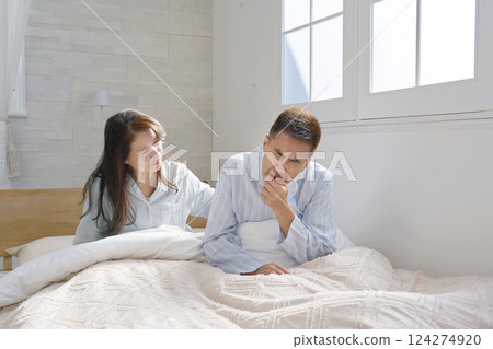 Man coughing on bed 124274920