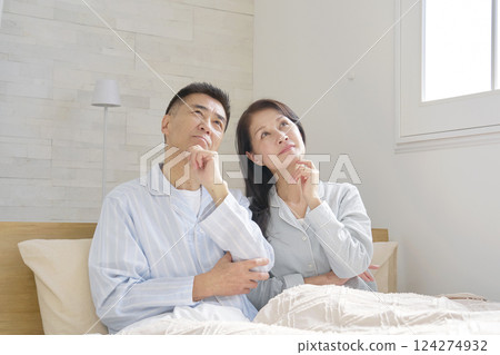 Couple in pajamas thinking Couple in pajamas thinking 124274932