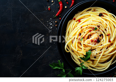 Delicious Plate of Linguine with Fried Chicken Liver and Spices on a Dark Background 124275003