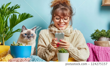 Young woman use smartphone to shopping online and communication with cute cat in home. 124275157