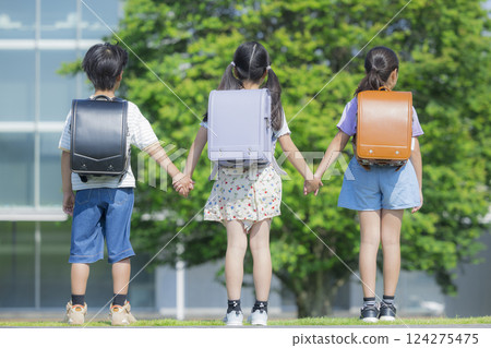Elementary school student carrying a backpack walking outdoors 124275475