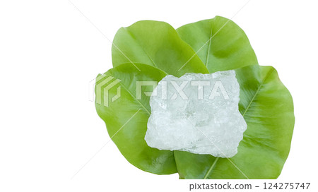 Crystal clear alum cubes or Potassium alum in on green leaves chemical compound substance concept for beauty spa and underarm treatment industrial 124275747