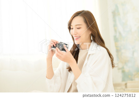 Woman holding a classic camera Woman holding a classic camera 124275812