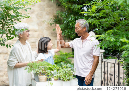 Senior couple and child gardening 124275916