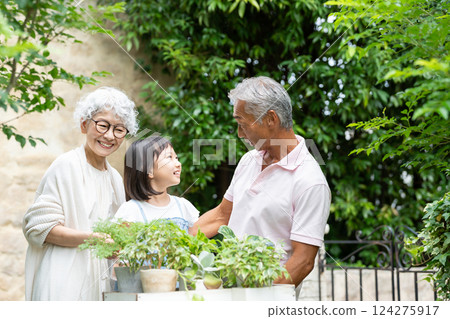 Senior couple and child gardening 124275917