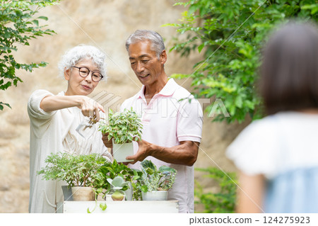 Senior couple and child gardening 124275923