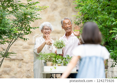 Senior couple and child gardening Senior couple and child gardening 124275926