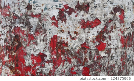 Red painted metal surface with torn pieces of paper and rust Red painted metal surface with torn pieces of paper and rust 124275966
