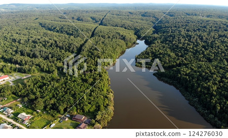 Nature on the Amur River in Russia. Serpentine river flowing through verdant woodland, capturing summer's vibrant greenery 124276030