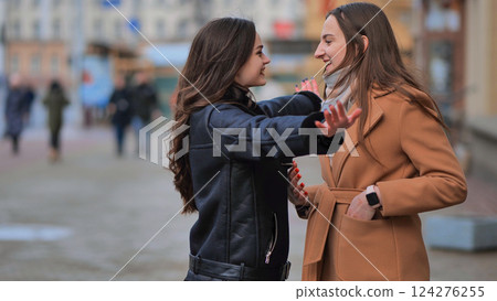 Two best friends meet on the streets of the city and hug. Two best friends meet on the streets of the city and hug. 124276255