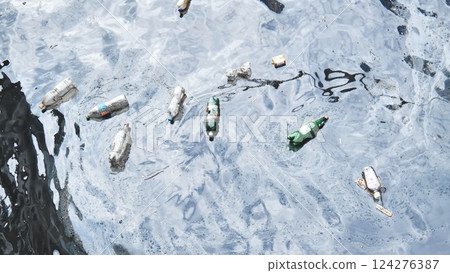 Plastic bottles and other garbage floating on polluted water surface, representing environmental pollution and plastic waste problem 124276387