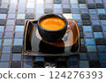 An espresso shot serving in classic black ceramic cup on amulticolored crystal  backgrounds. 124276393