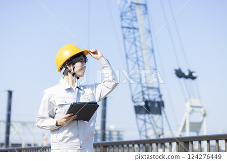 Woman in work clothes at a construction site 124276449