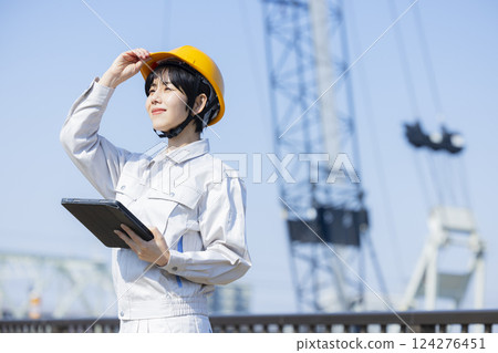 Woman in work clothes at a construction site 124276451