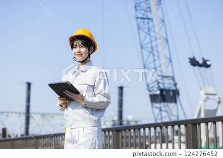 Woman in work clothes at a construction site 124276452