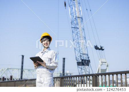 Woman in work clothes at a construction site 124276453