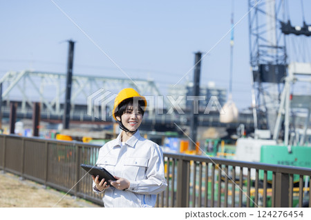 Woman in work clothes at a construction site 124276454