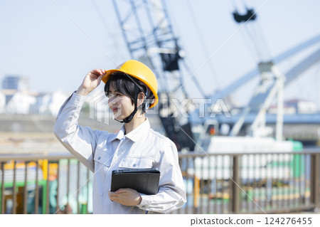 Woman in work clothes at a construction site 124276455