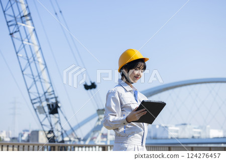 Woman in work clothes at a construction site 124276457
