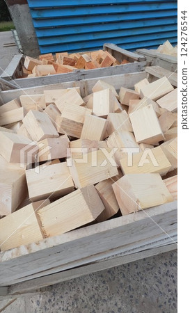Wooden blocks filling two large crates in a lumber yard Wooden blocks filling two large crates in a lumber yard 124276544
