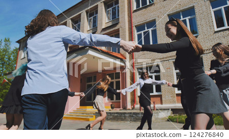 High school students dancing and having fun in the sunshine, embracing their youth and friendship outside of their school High school students dancing and having fun in the sunshine, embracing their youth and friendship outside of their school 124276840