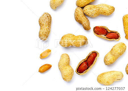 Roasted peanuts in shell on white background. Roasted peanuts in shell on white background. 124277037