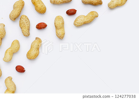 Roasted peanuts in shell on white background. Roasted peanuts in shell on white background. 124277038
