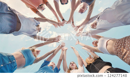 School friends joining hands in a circle, representing their close knit bond and unity School friends joining hands in a circle, representing their close knit bond and unity 124277148