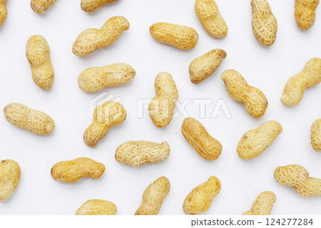 Roasted peanuts in shell on white background. Roasted peanuts in shell on white background. 124277284