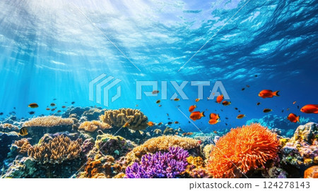 A beautiful coral reef with a variety of fish swimming around 124278143