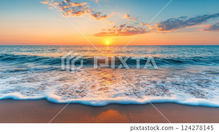 The ocean is calm and the sun is setting, creating a beautiful 124278145