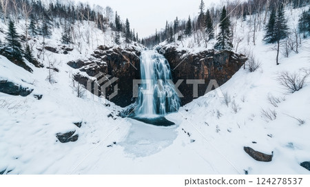 A snow covered mountain with a large waterfall 124278537