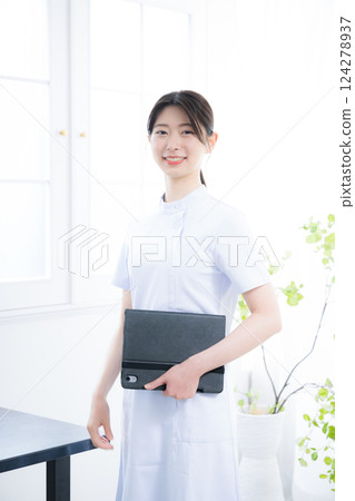 Smiling nurse holding a chart looking at the camera Smiling nurse holding a chart looking at the camera 124278937