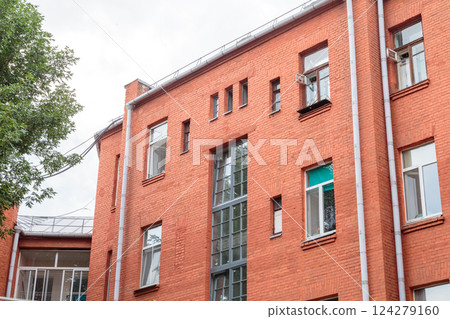 The facade of the old red brick building that was The facade of the old red brick building that was 124279160