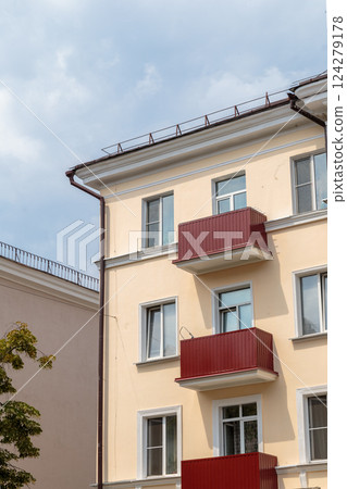 The facade of a modern building in which people The facade of a modern building in which people 124279178